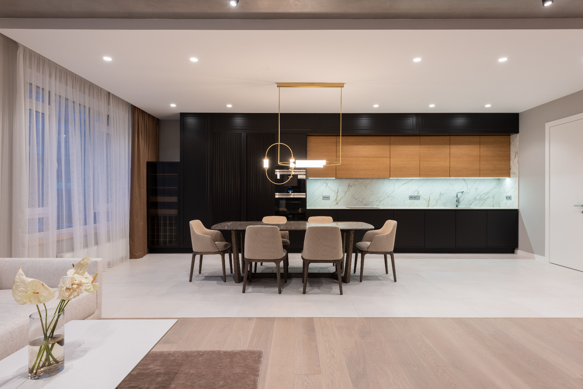 Modern open-concept kitchen and dining area with custom recessed lighting installed by West Coast Power & Lighting