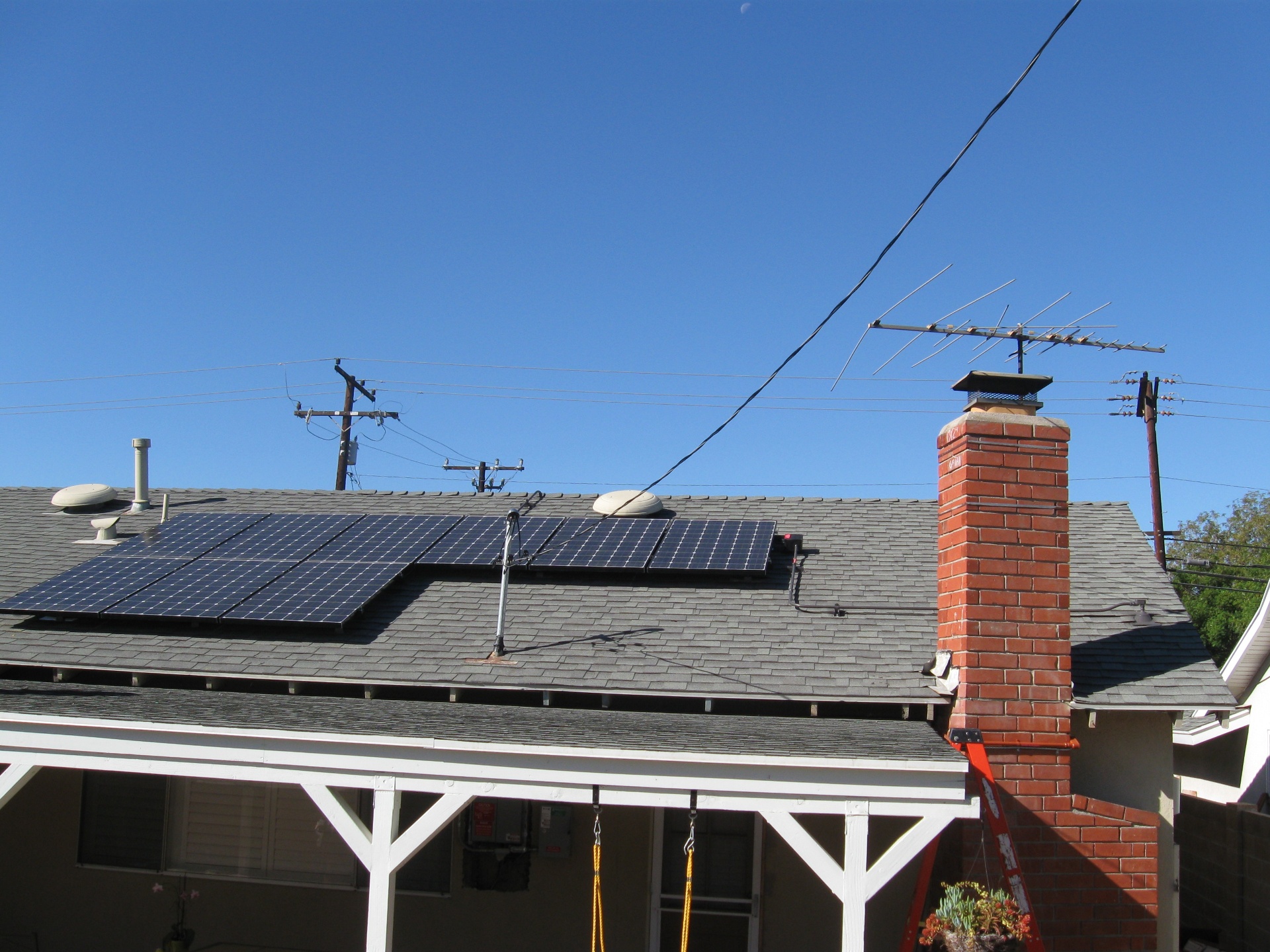 Residential rooftop solar photovoltaic panel array installed on a composition shingle roof